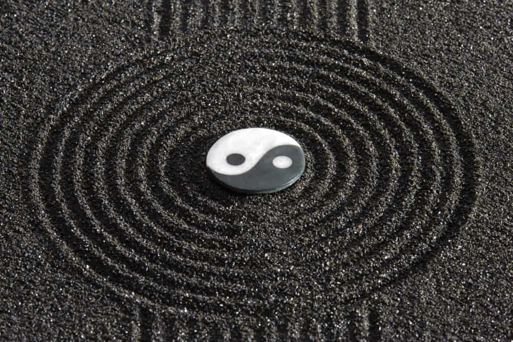 an image of sand and a yin yang symbol