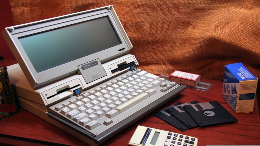 a photo of a very old computer and floppy disks