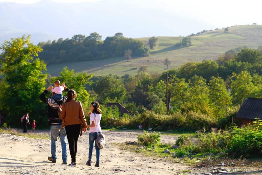 A photo of a family walking on a mountain trail