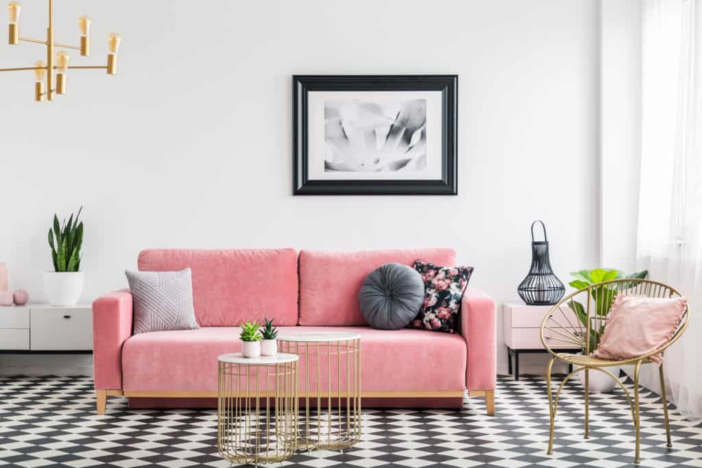 a photo of a modern glam interior design with a pink sofa