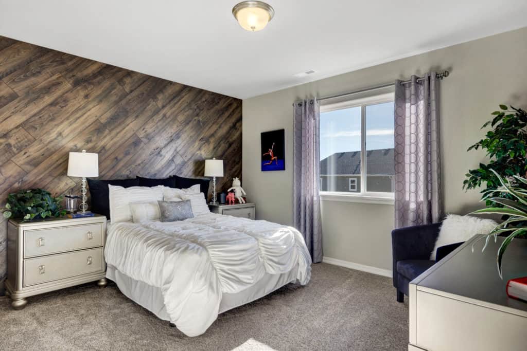 a photo of a bedroom with a decorative wood wall