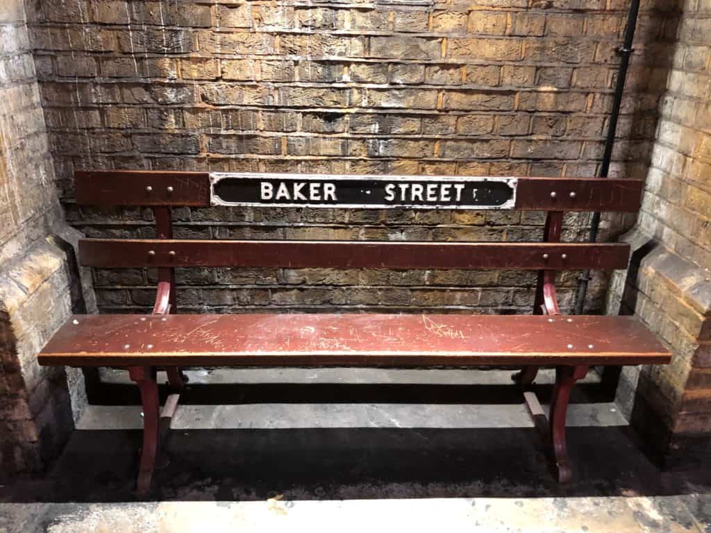 a photo of a Baker Street sign on a bench in the London Underground