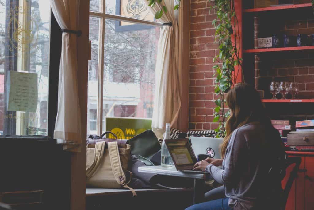 a photo of a girl working at a computer