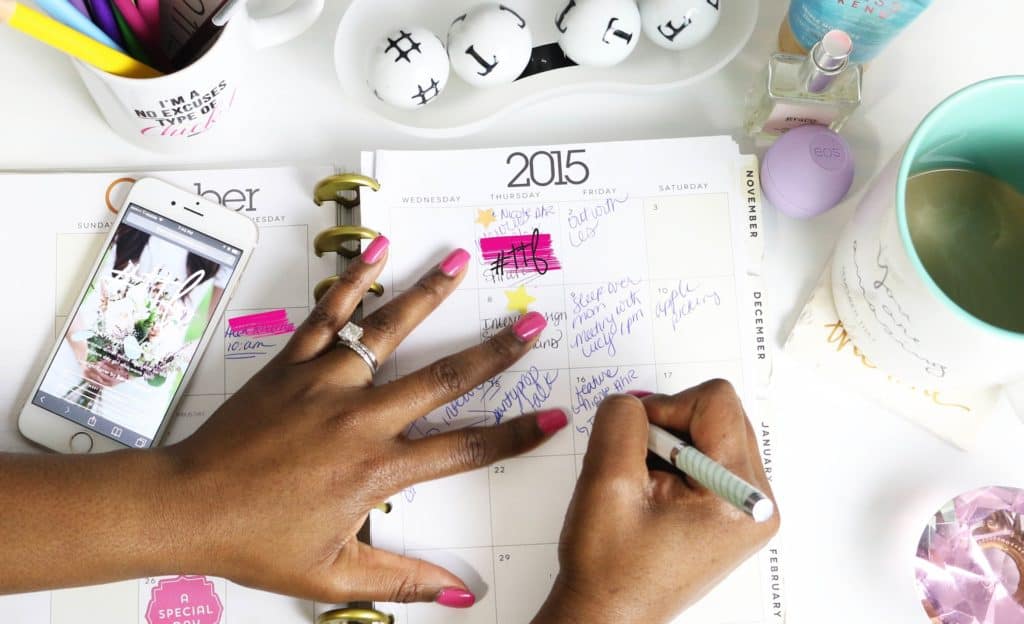 a photo of a woman using a day planner