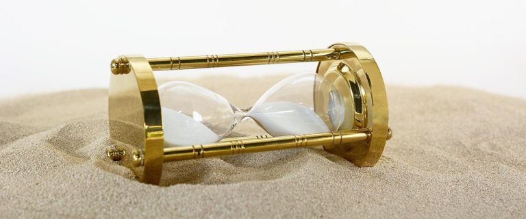 a photo of an hourglass lying in the sand task list