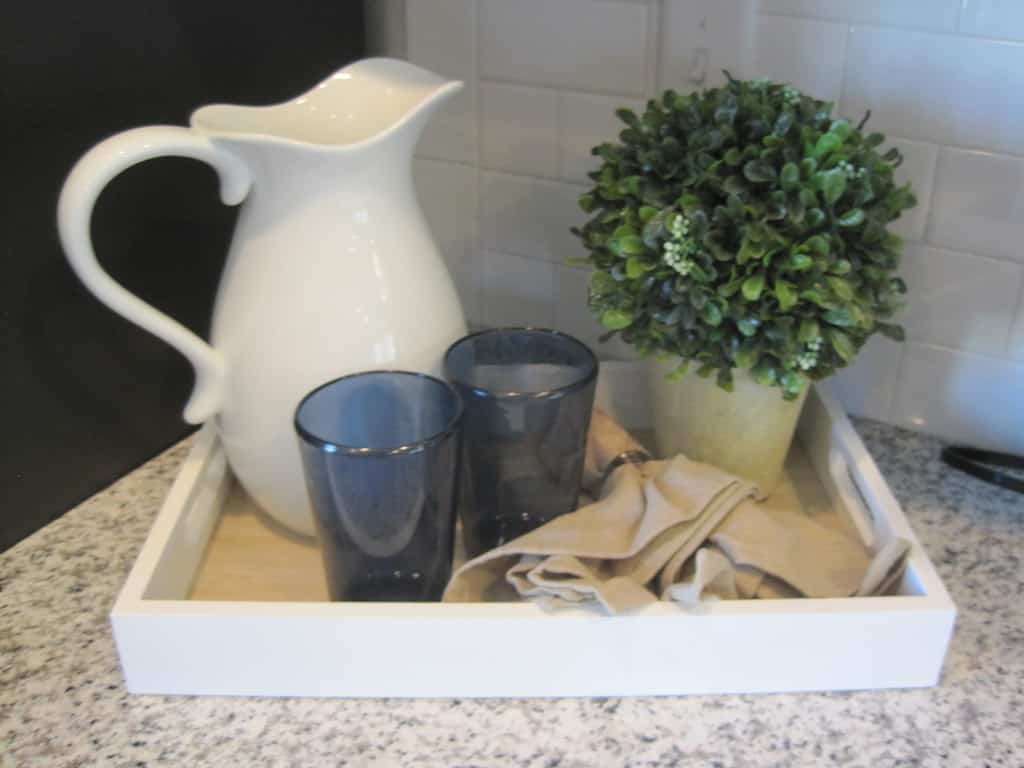 An Amazing Accessory vignette a photo of a pitcher, glasses and plant in a basket