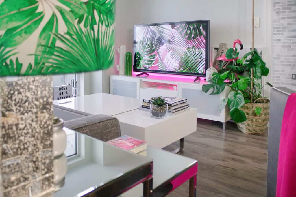 A photo of an interior living room design with pops of magenta color