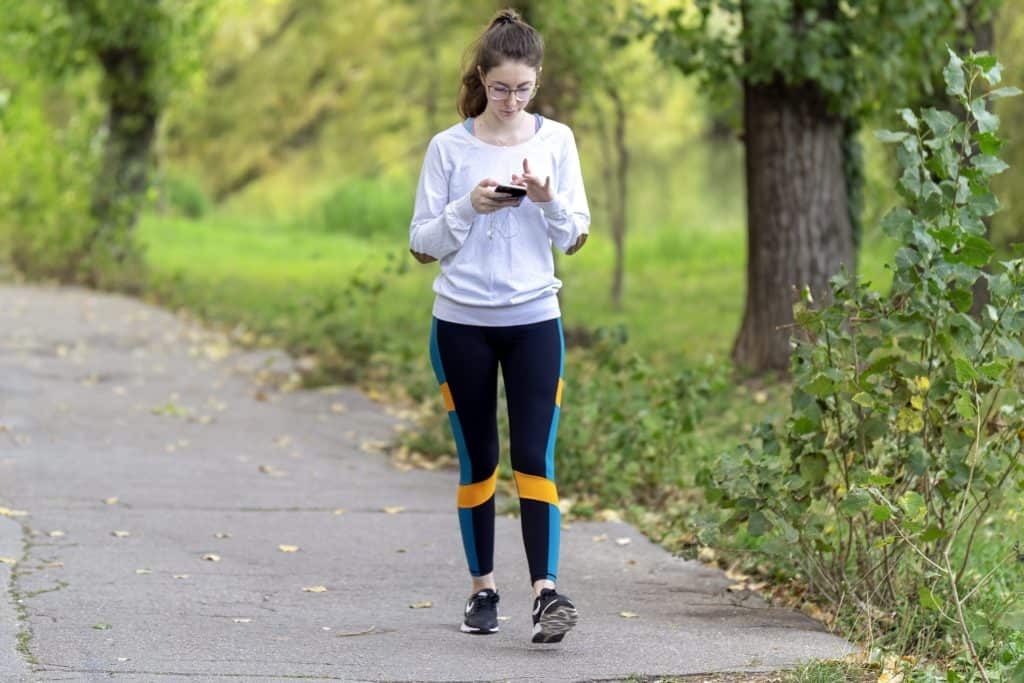 a photo of a woman walking for a workout healthy hacks