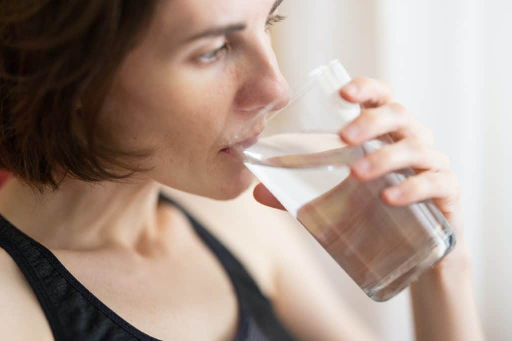 a photo of a woman drinking a glass of water